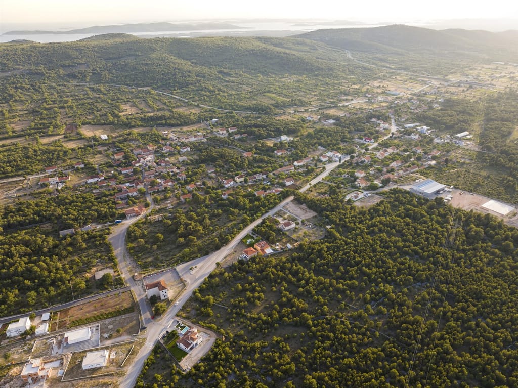 Aerial view of Dubrava village with the Adriatic and its islands on the horizon